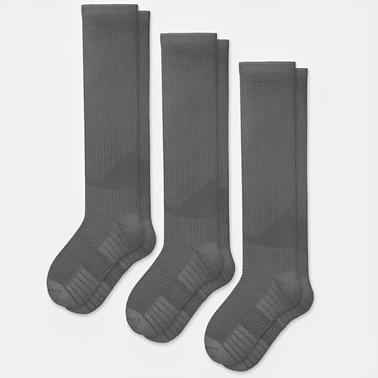 Gray seamless compression socks that stretch over the calf with no ridge at the toe