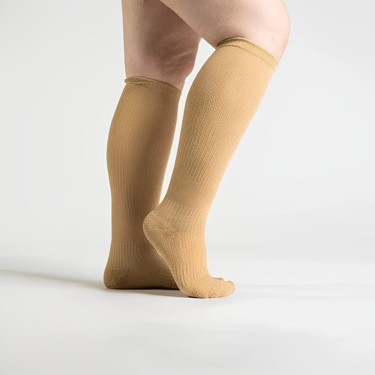Beige seamless compression socks with a smooth toe and a stretchy calf