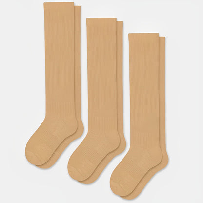 Beige seamless compression socks with a smooth toe and a stretchy calf