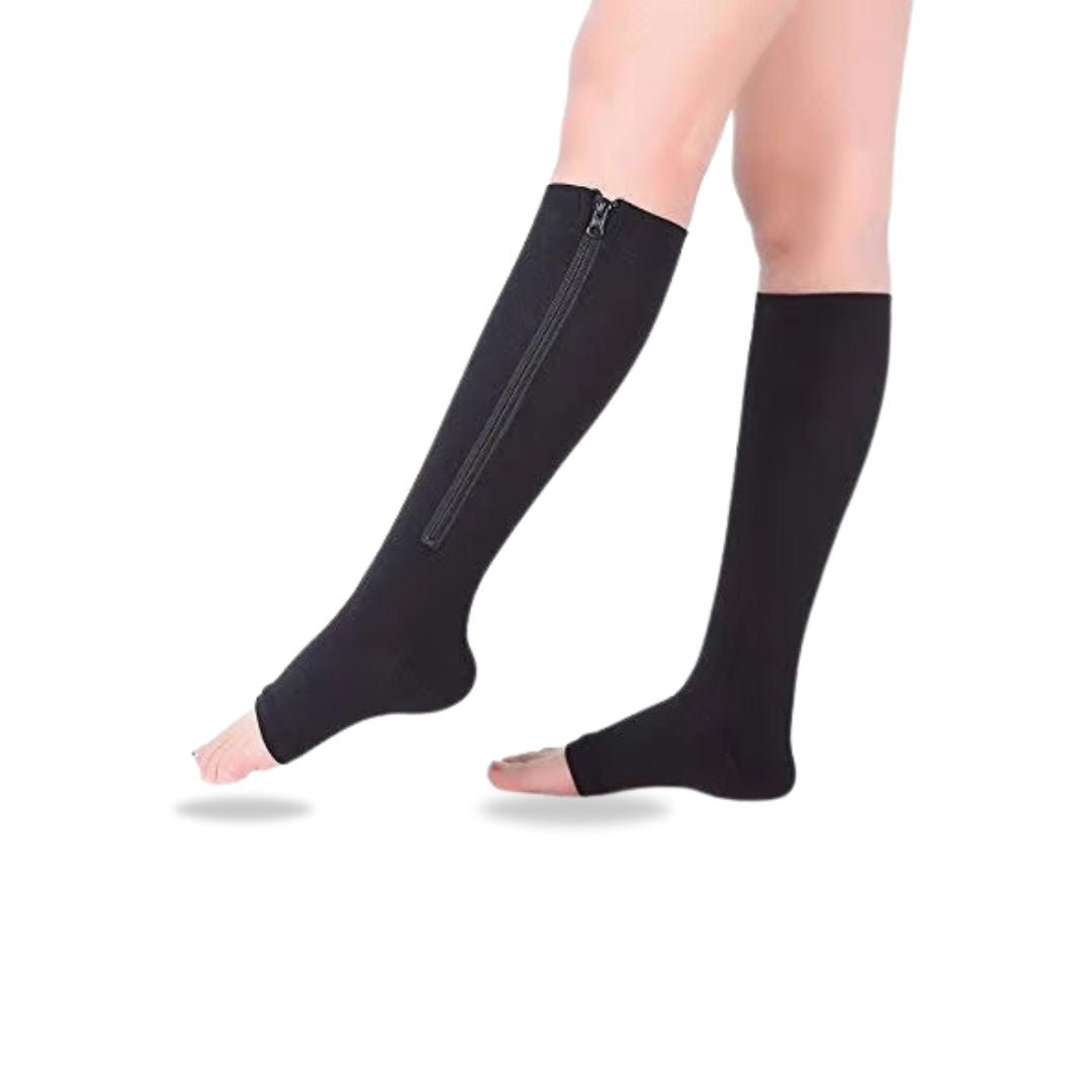 Women's compression socks in black and nude with a zipper running up the side of the calf