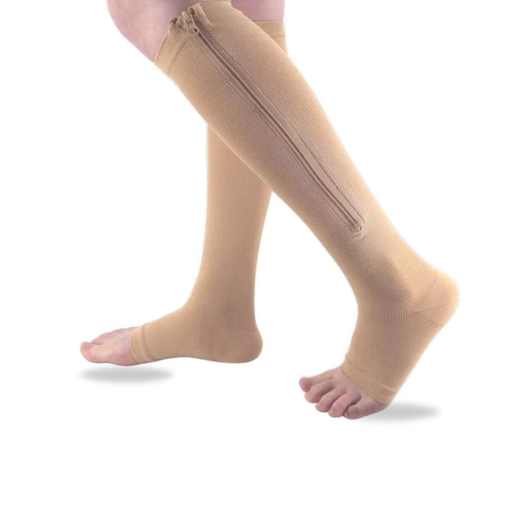 Women's compression socks in black and nude with a zipper running up the side of the calf