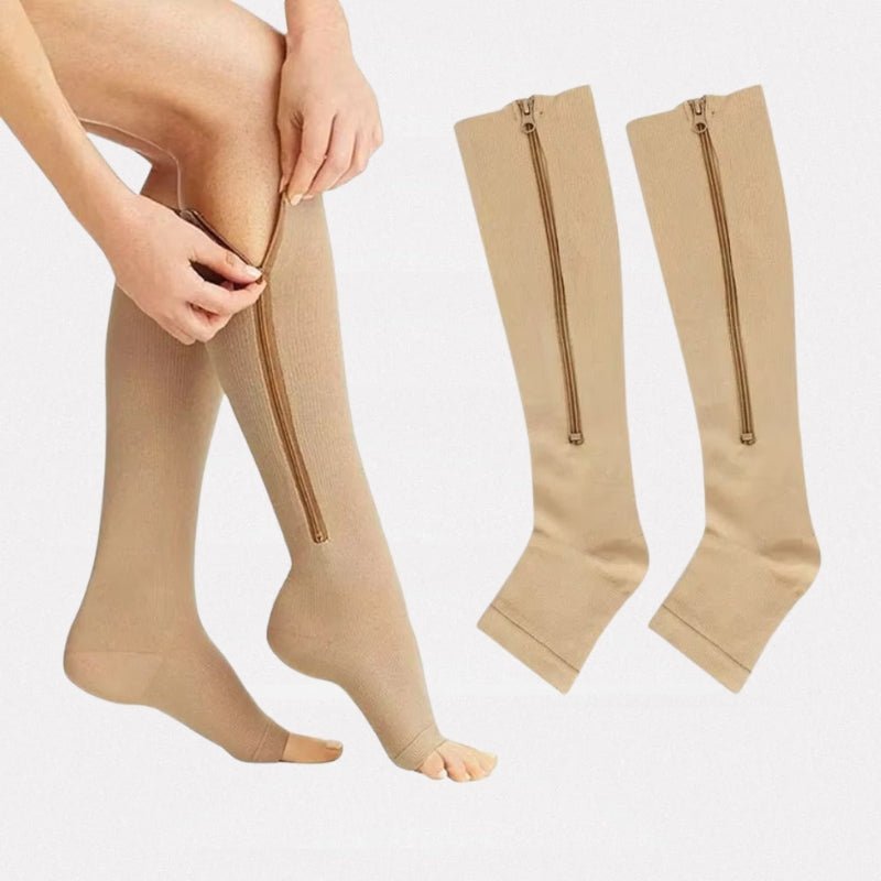 Women's compression socks in black and nude with a zipper running up the side of the calf