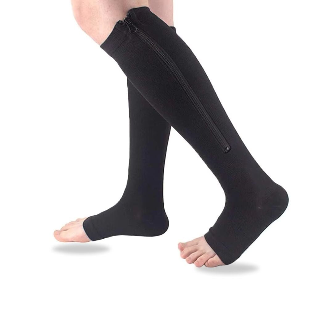 Women's compression socks in black and nude with a zipper running up the side of the calf