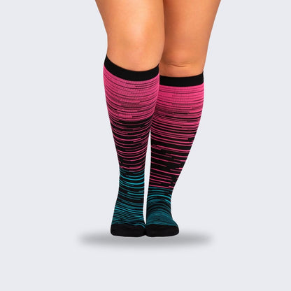 Two-tone 20-30 mmHg compression socks worn up the calf, in black, pink, blue and light blue