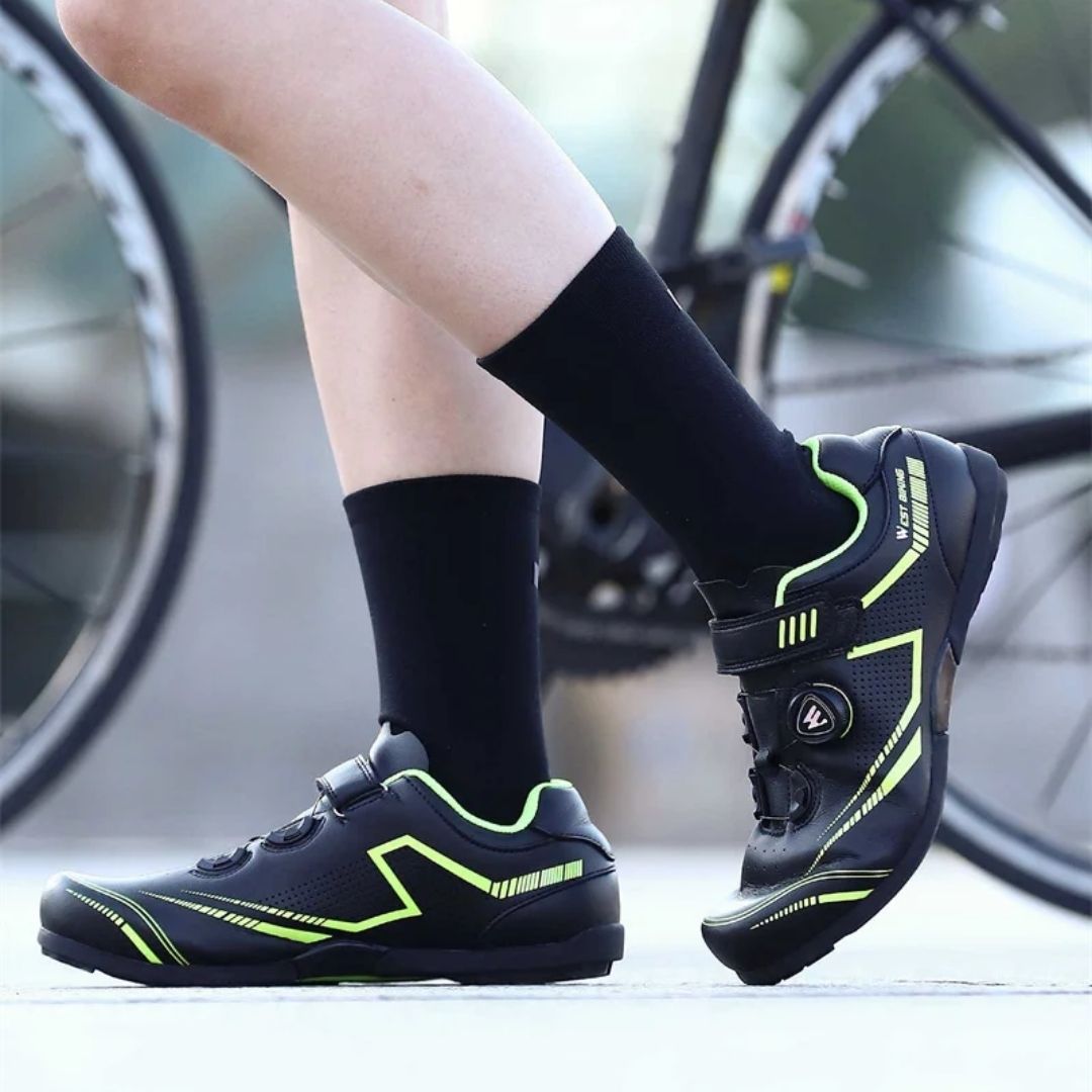 Black cycling socks with reflective stripes, worn high on the calf