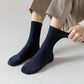 Bamboo fiber crew socks worn at the ankle, in five-pair packs of black, gray or navy