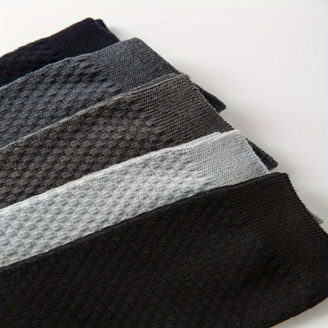 Bamboo fiber crew socks worn at the ankle, in five-pair packs of black, gray or navy