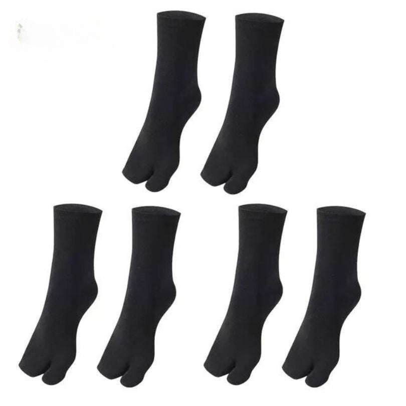 Gray, black and white socks shaped to fit around a bunion corrector on the big toe