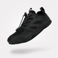 Gray barefoot hiking shoes with a grippy thin outsole and a wide toe box