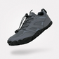 Gray barefoot hiking shoes with a grippy thin outsole and a wide toe box