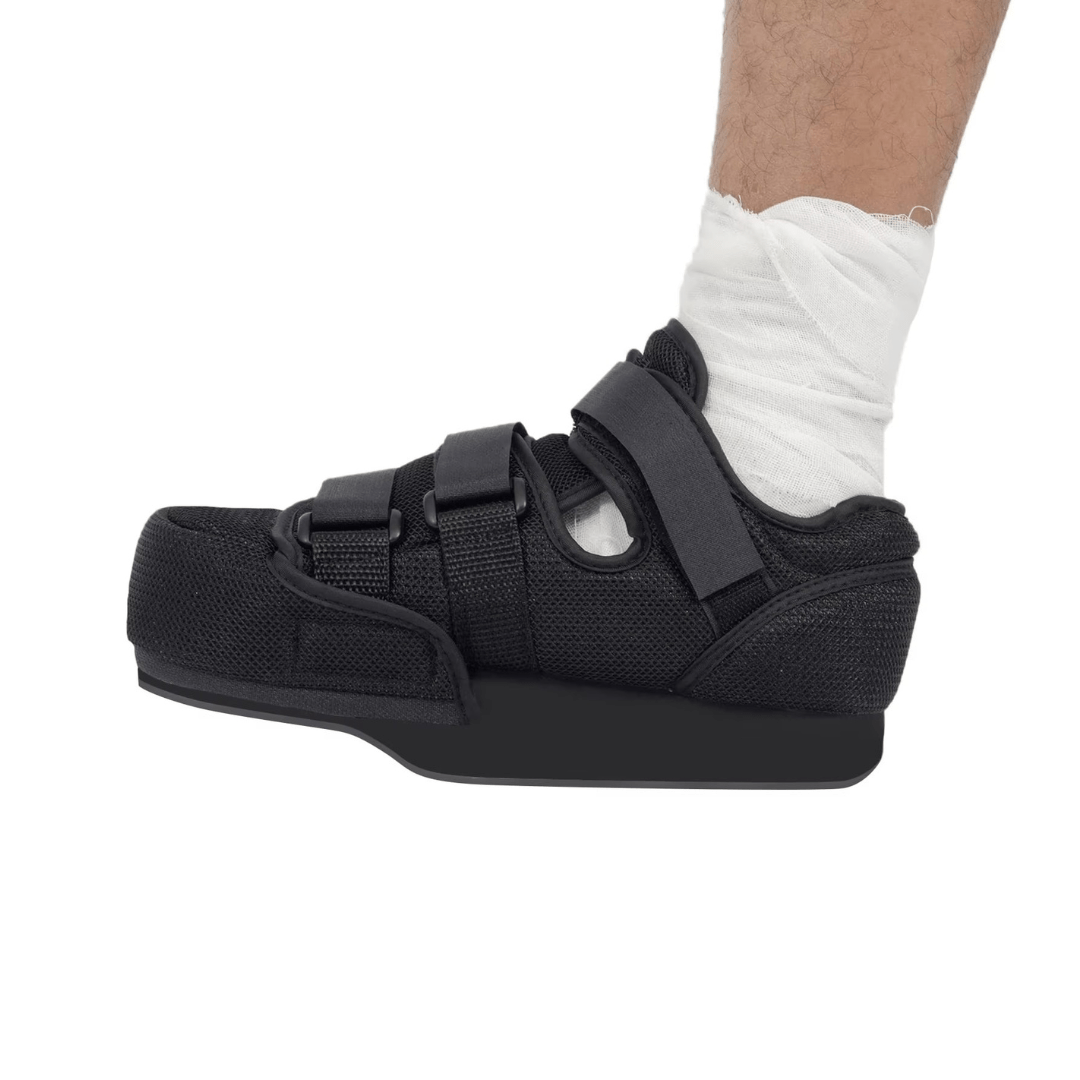 Post-op offloading shoe with adjustable straps and a rigid non-slip sole for a bandaged foot