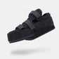 Post-op offloading shoe with adjustable straps and a rigid non-slip sole for a bandaged foot
