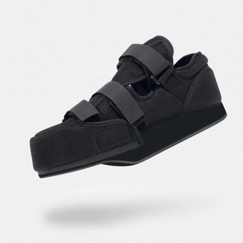 Post-op offloading shoe with adjustable straps and a rigid non-slip sole for a bandaged foot