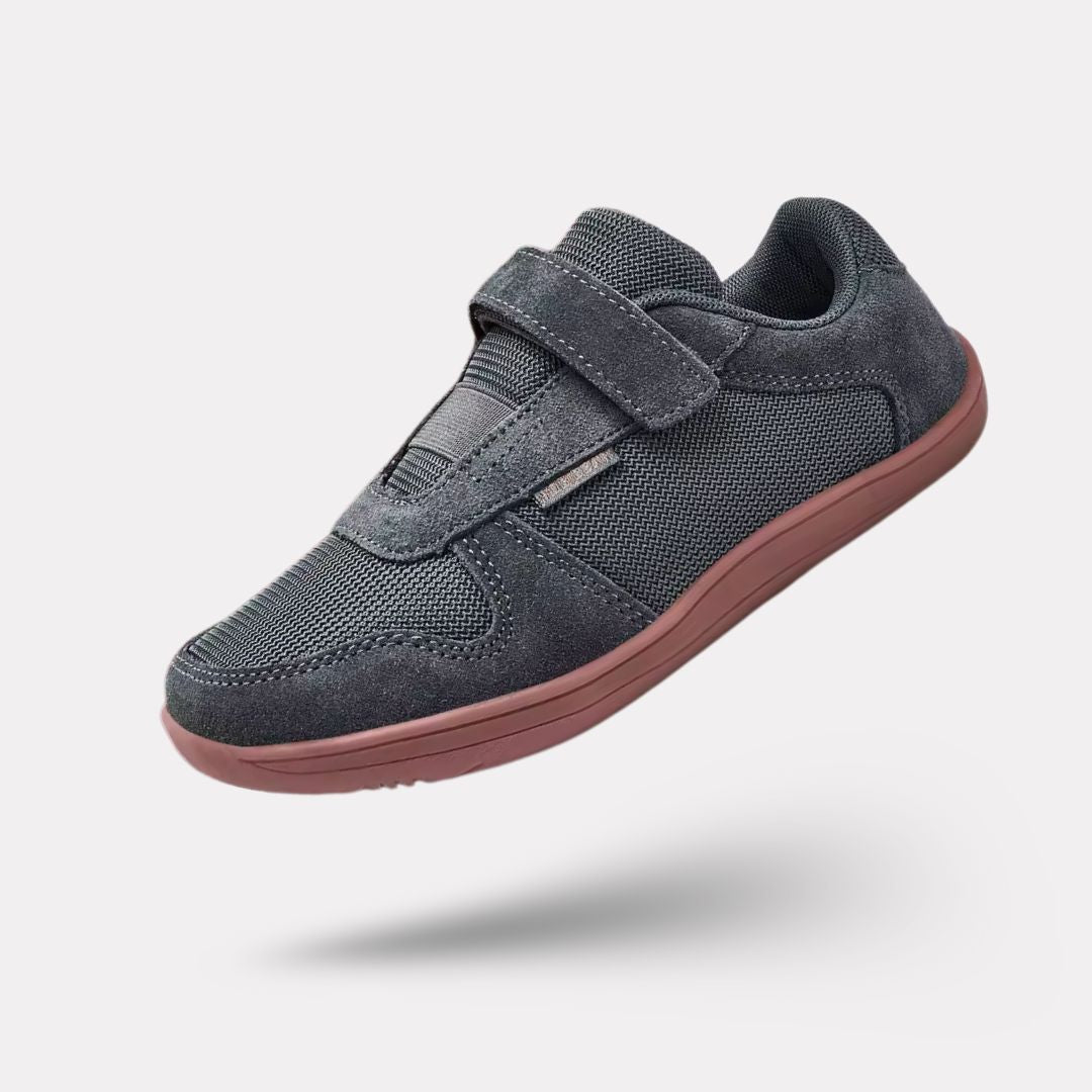 Blue barefoot shoes for kids with a thin flexible sole and a roomy toe box