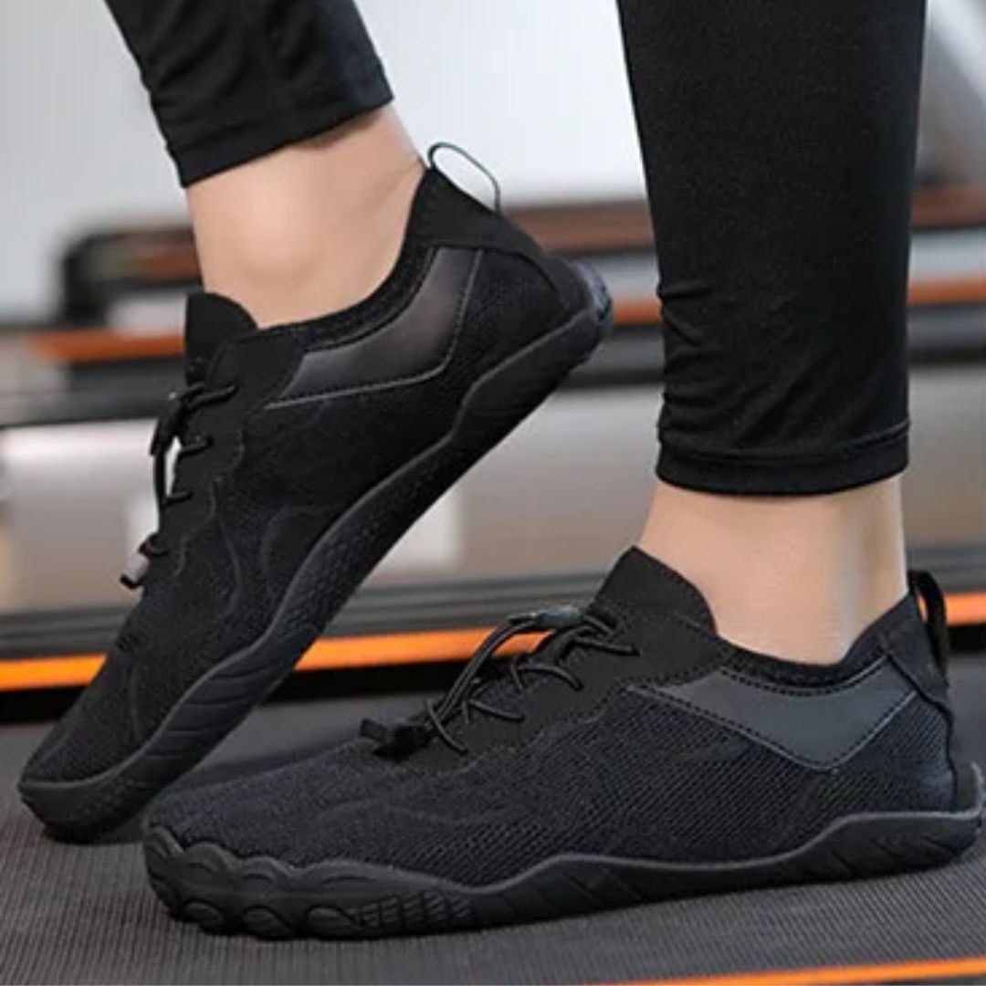 Light gray minimalist barefoot sneakers with a flat sole and a wide toe box