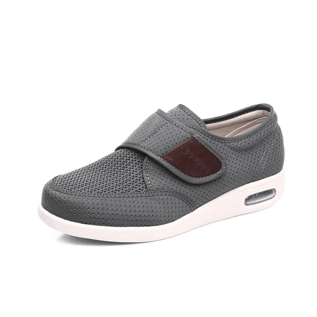 Black wide orthopedic shoes with hook-and-loop straps across the instep