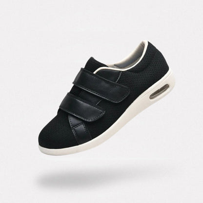 Orthopedic shoes with a wide hook-and-loop strap across the instep for easy slip-on