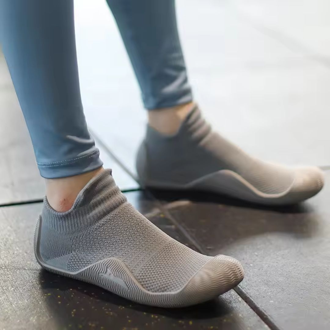 Soft barefoot style orthopedic shoes with a thin flexible sole, in gray, black, white or purple