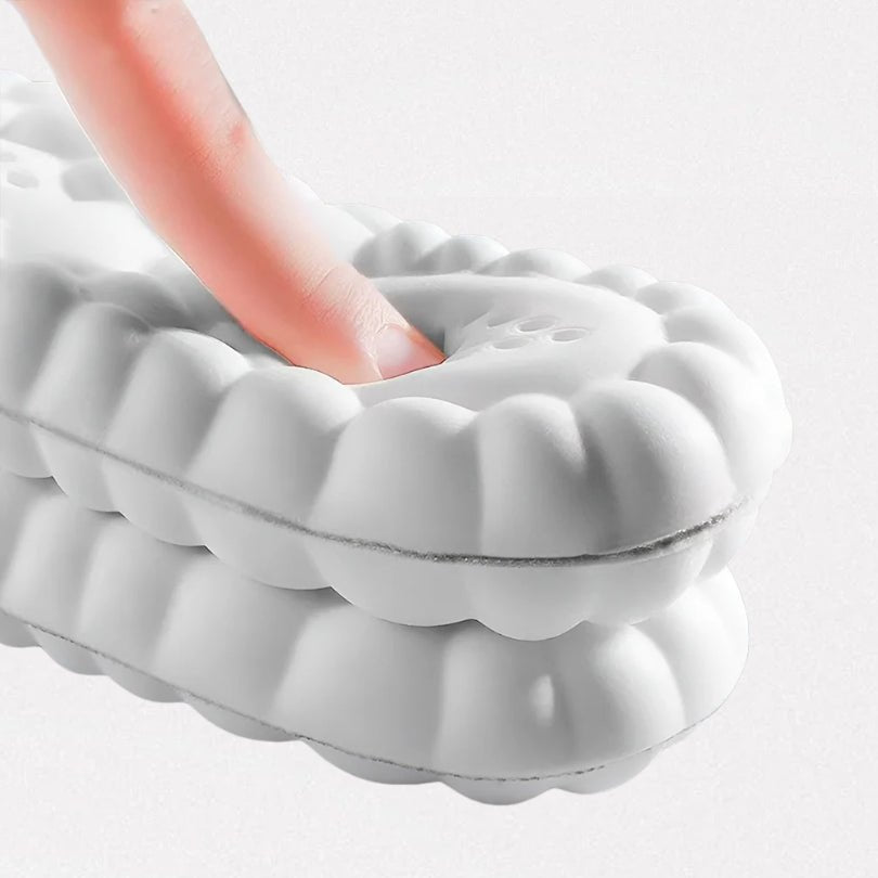 Pair of orthopedic insoles with layered cushioning under the heel and arch