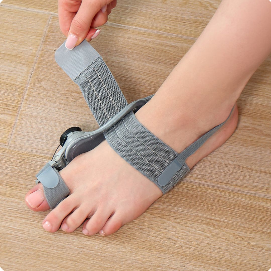 Bunion corrector strap worn over the big toe joint to hold the toe in line
