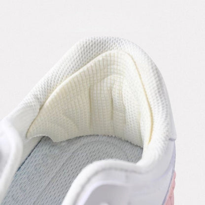 Clear adhesive anti-friction pads trimmed to fit the back of the heel