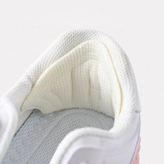 Clear adhesive anti-friction pads trimmed to fit the back of the heel