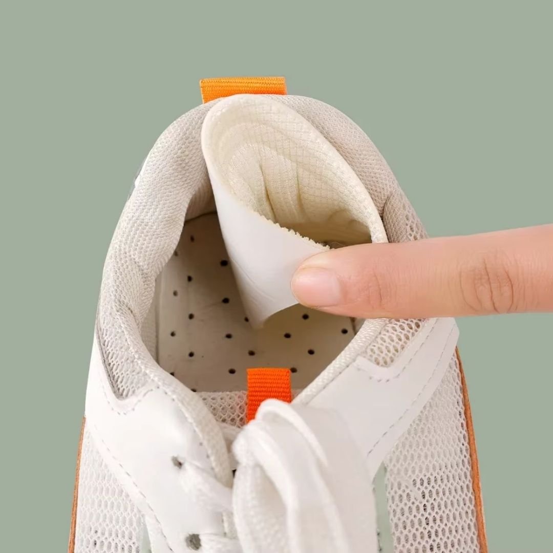 Clear adhesive anti-friction pads trimmed to fit the back of the heel