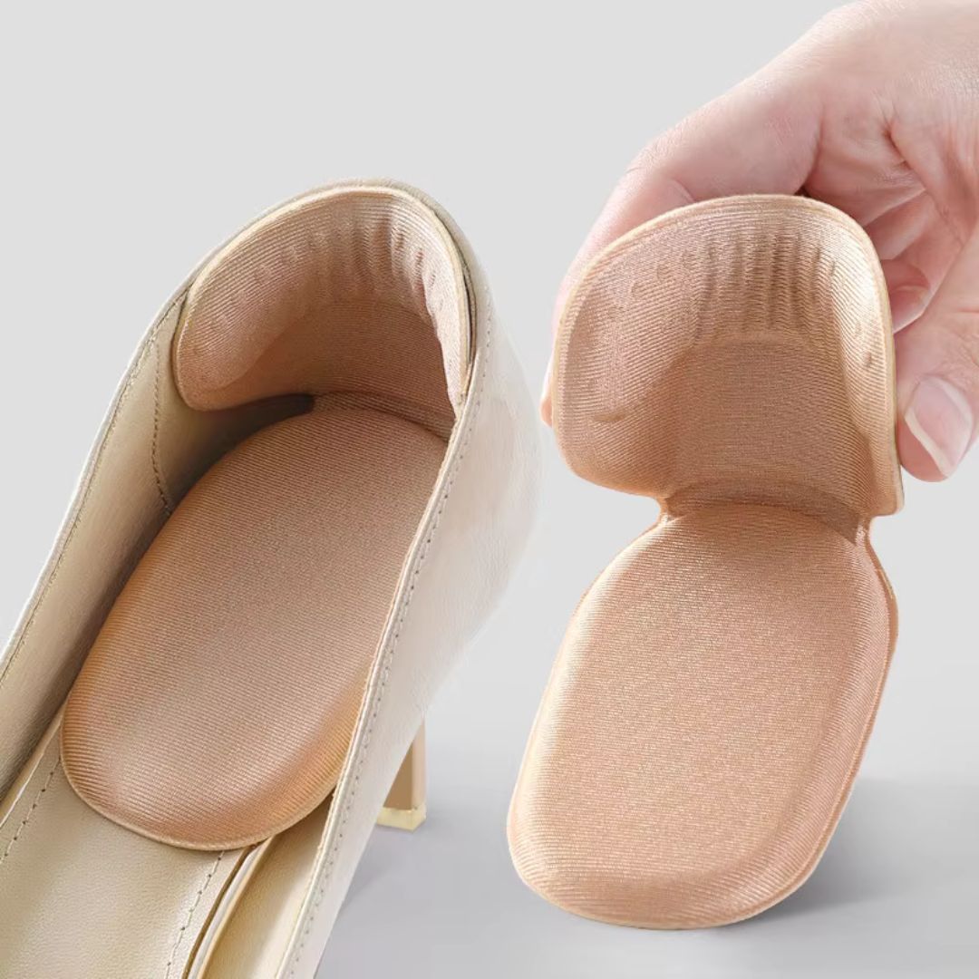 Clear anti-friction pads in black and beige, stuck inside the back of a high heel
