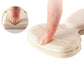 Clear anti-friction pads in black and beige, stuck inside the back of a high heel