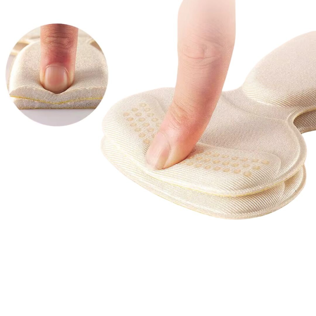 Clear anti-friction pads in black and beige, stuck inside the back of a high heel