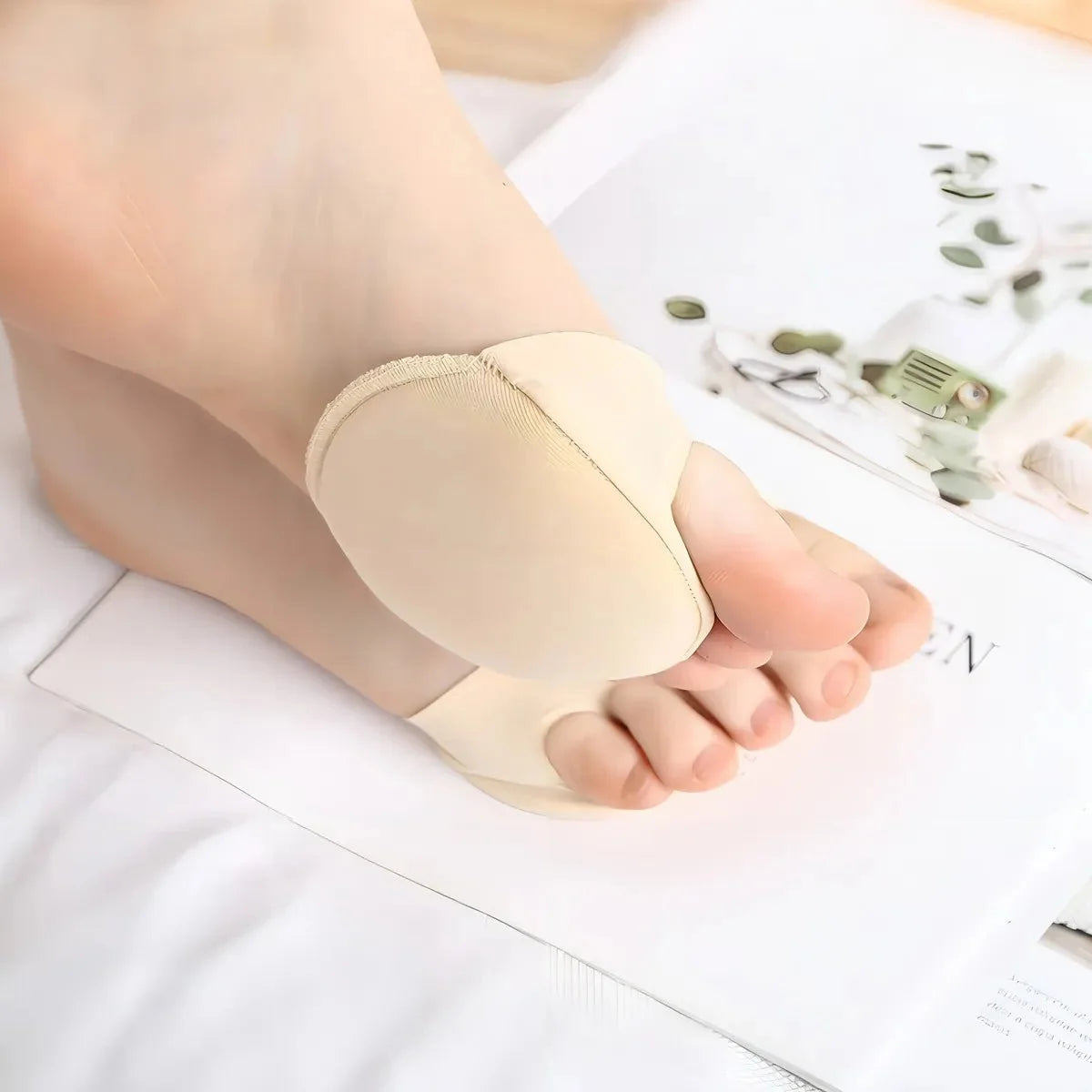 Gel metatarsal pads in nude or clear black, placed under the ball of the foot in heels