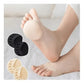 Gel metatarsal pads in nude or clear black, placed under the ball of the foot in heels