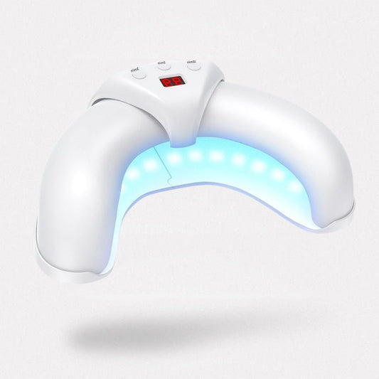 Handheld UV device clipped over a toenail to treat fungal infection