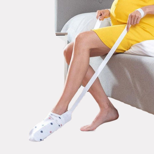 Compression sock donner, a curved slide with side handles for pulling a sock on