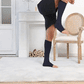 Breathable open-toe compression socks in black and beige, worn up the calf