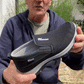Black orthopedic walking shoes for men with a cushioned midsole and lace-up fit