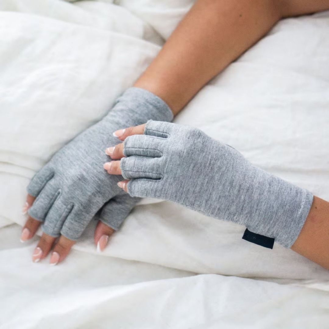 Fingerless compression gloves worn over the hands for arthritis relief