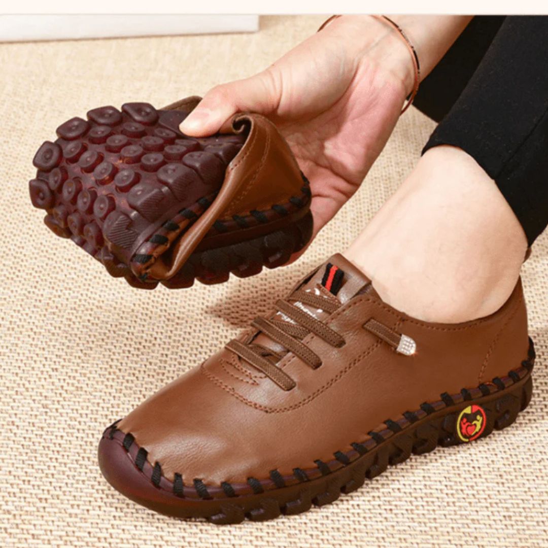 Orthopedic loafers with a slip-on upper and cushioned sole, in black, brown, white and red