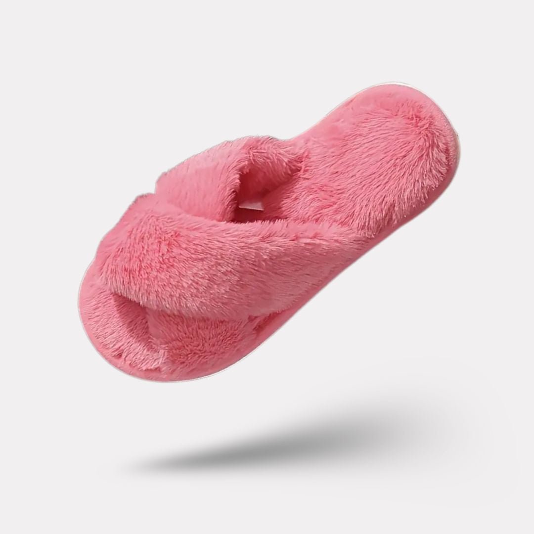 Pink fluffy slippers with a thick plush lining covering the whole foot