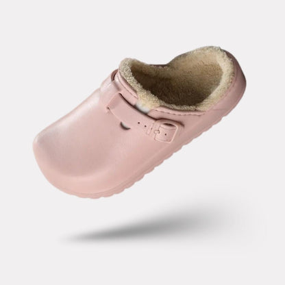 Women's fur-lined slippers in pink, black and white with a closed round toe