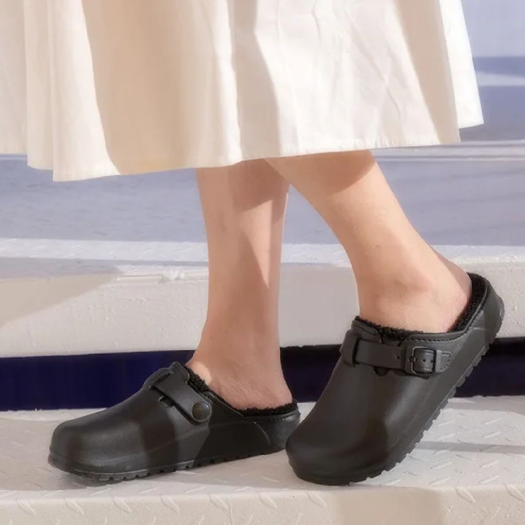 Women's fur-lined slippers in pink, black and white with a closed round toe