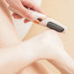 Pink handheld electric callus remover with a rotating roller head for the heel