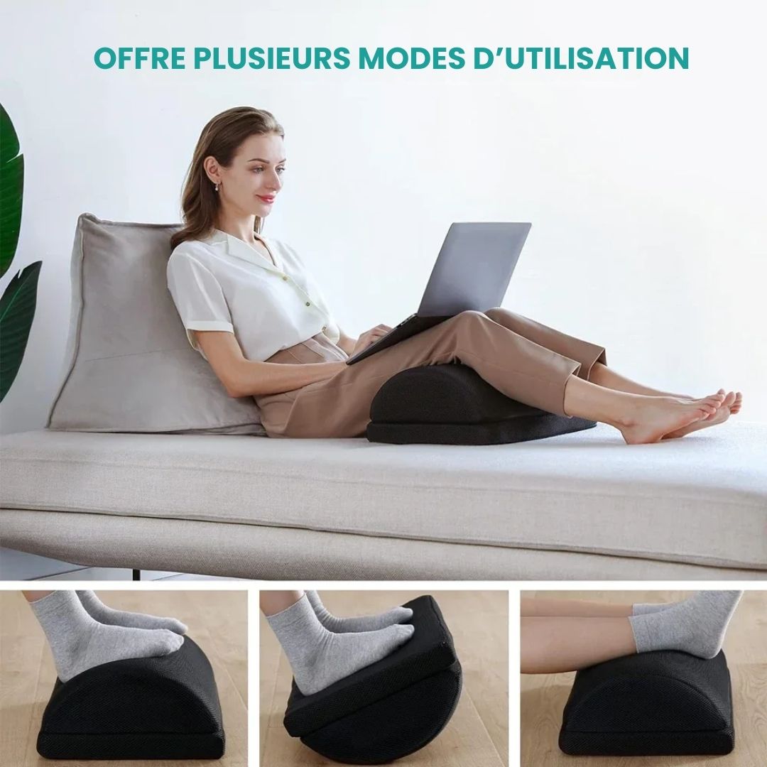 Angled ergonomic footrest placed under a desk to support both feet while seated