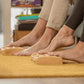 Ridged massage roller rolled underfoot to release plantar tension