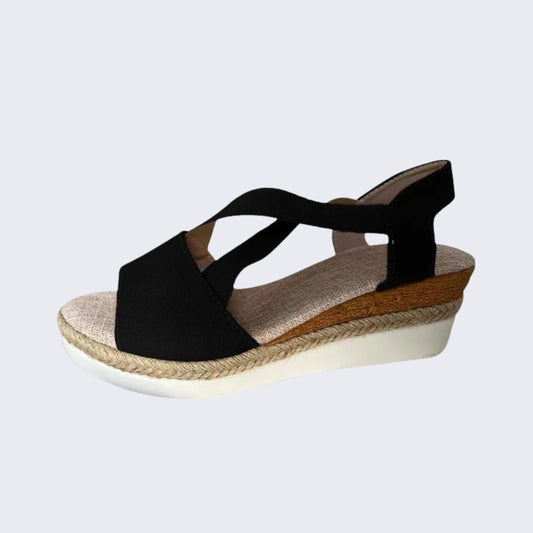 Pink wedge sandals with a cushioned orthopedic footbed and wide crossover strap