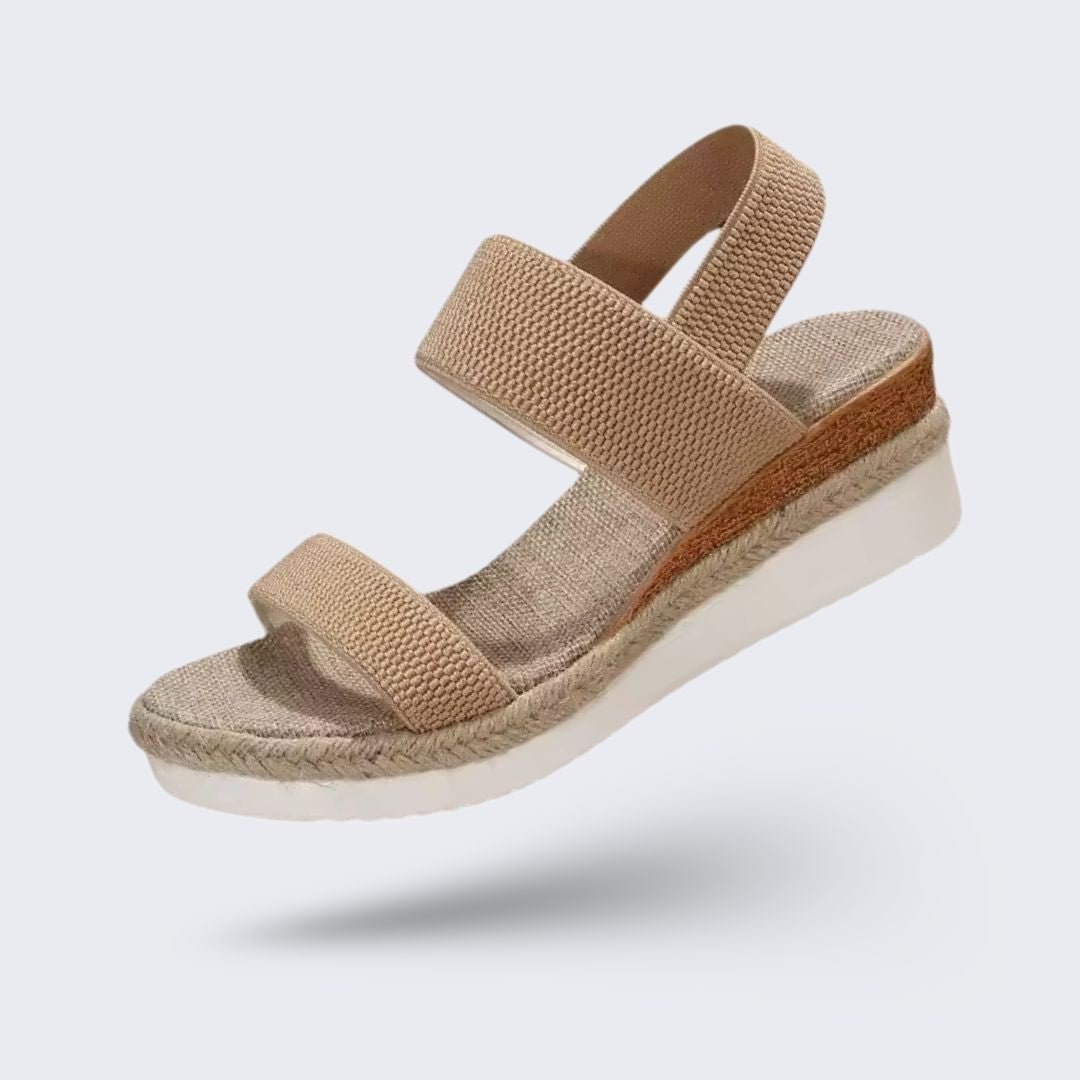 Beige wedge sandals for women with a raised heel and arch supporting footbed