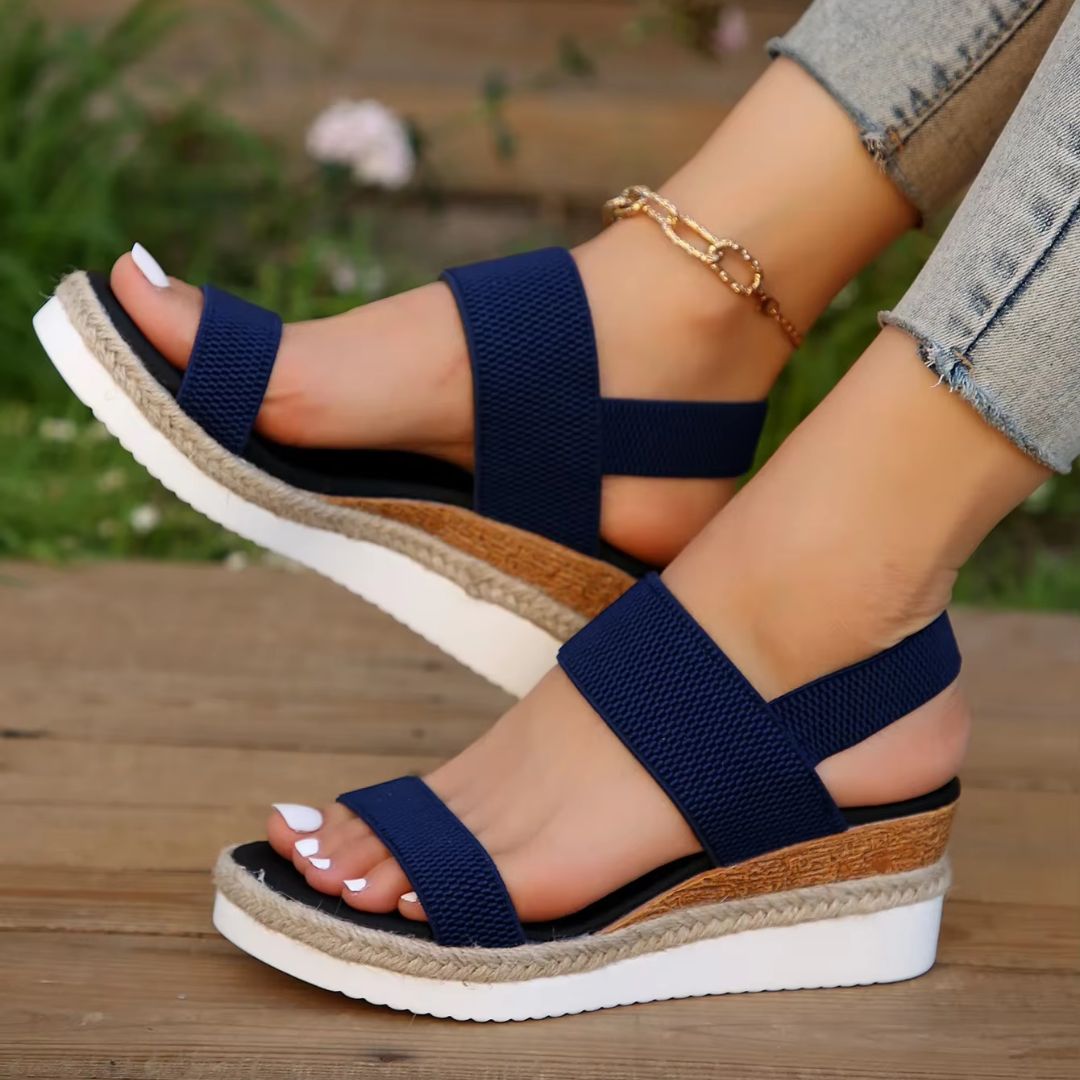 Beige wedge sandals for women with a raised heel and arch supporting footbed