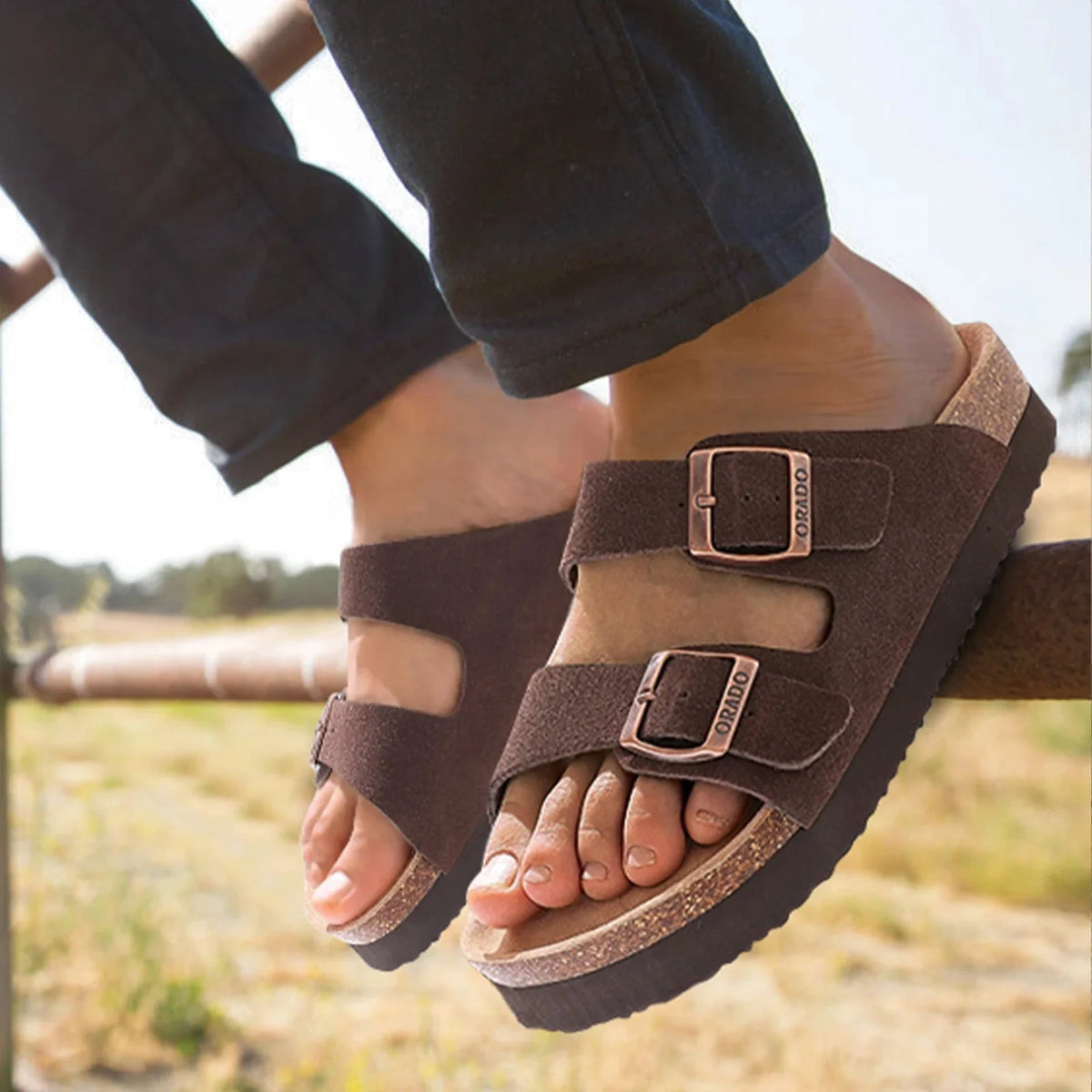 Cream sandals with two buckle straps and a contoured cork footbed