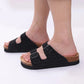 Cream sandals with two buckle straps and a contoured cork footbed
