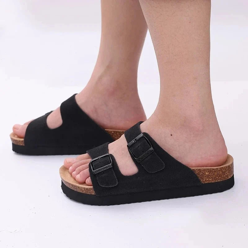 Cream sandals with two buckle straps and a contoured cork footbed